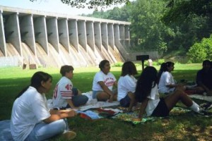 Students seated at dam copy